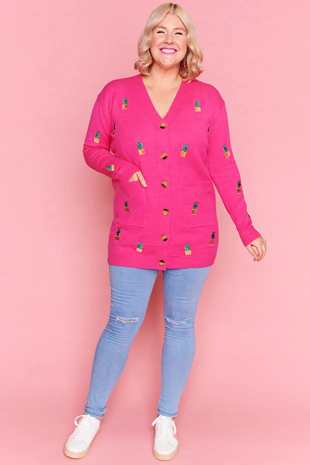Angela Plants On Pink Cardi
