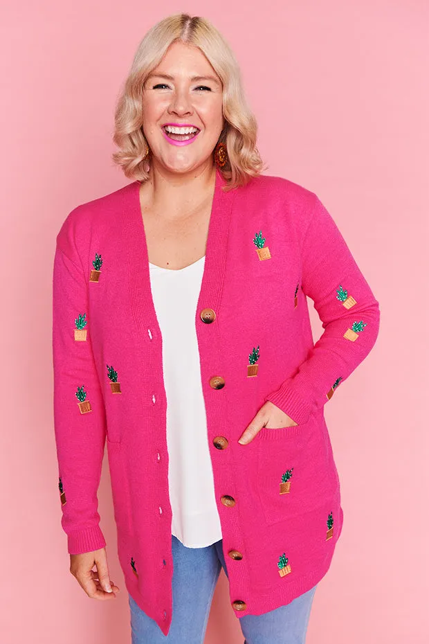 Angela Plants On Pink Cardi