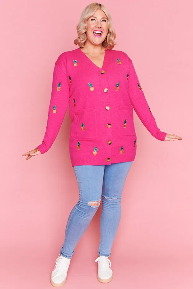 Angela Plants On Pink Cardi