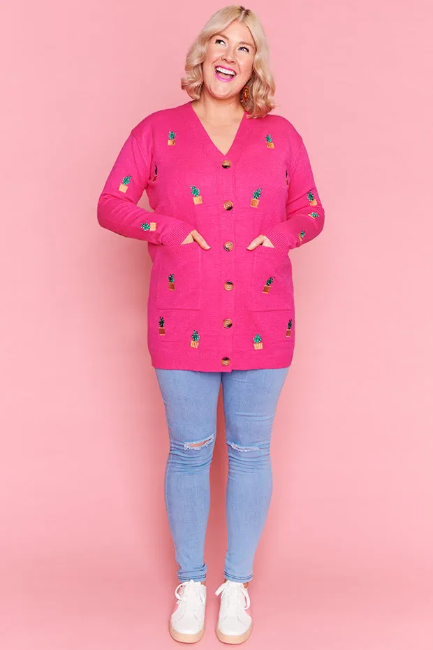 Angela Plants On Pink Cardi